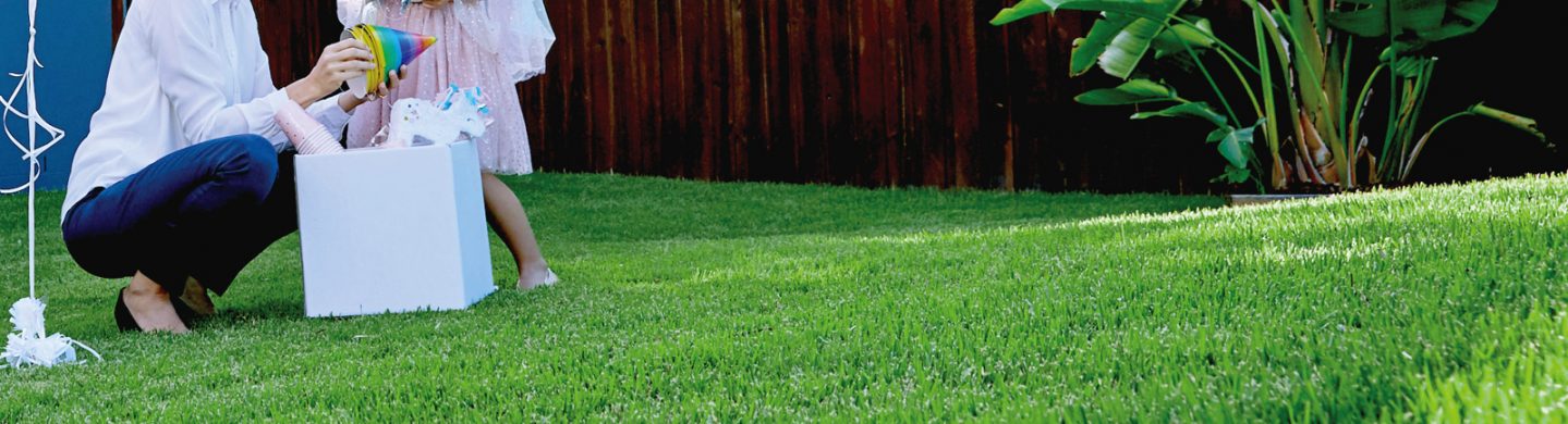 Family Celebrating Birthday Party on Lush Green Zoysia Turf