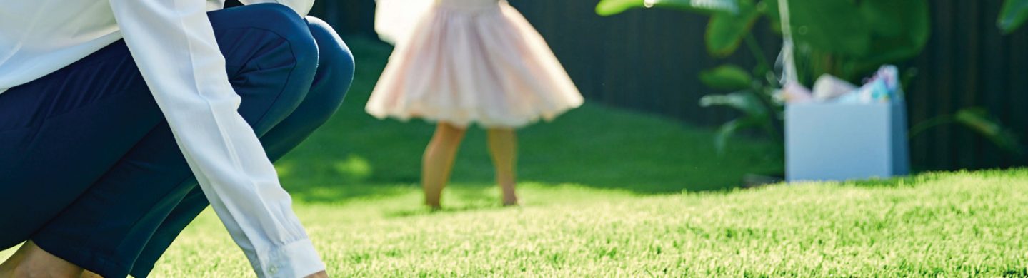 Woman Running Her Hand Through Empire Zoysia Grass