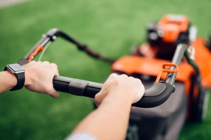 lawn mower being used on backyard